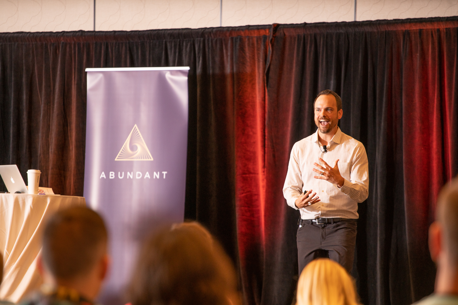 John Israel speaking on stage at the Abundant Leadership Experience